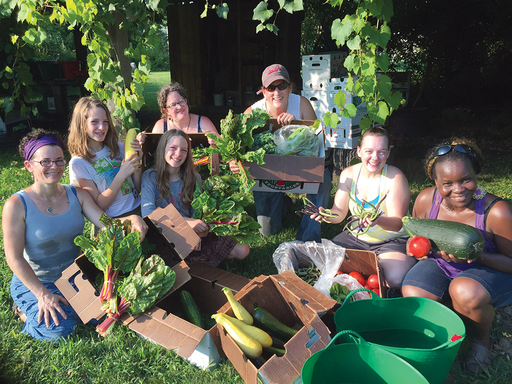Keene Community Garden group with some of the harvest.