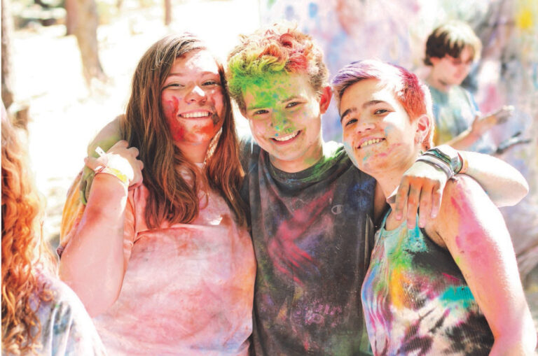 Three people smiling for photo after chalk run