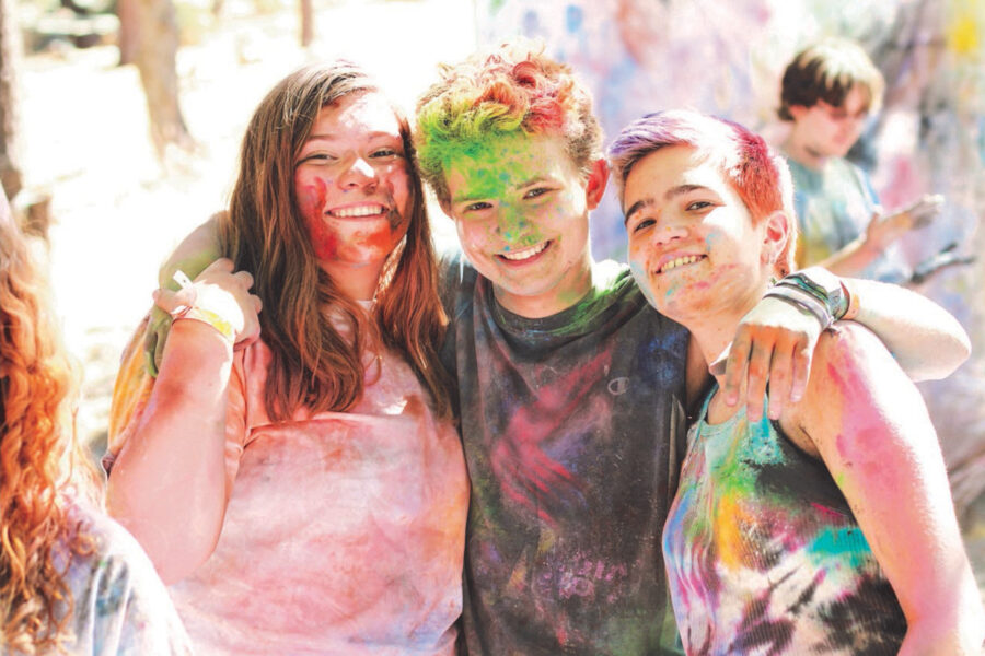 Three people smiling for photo after chalk run