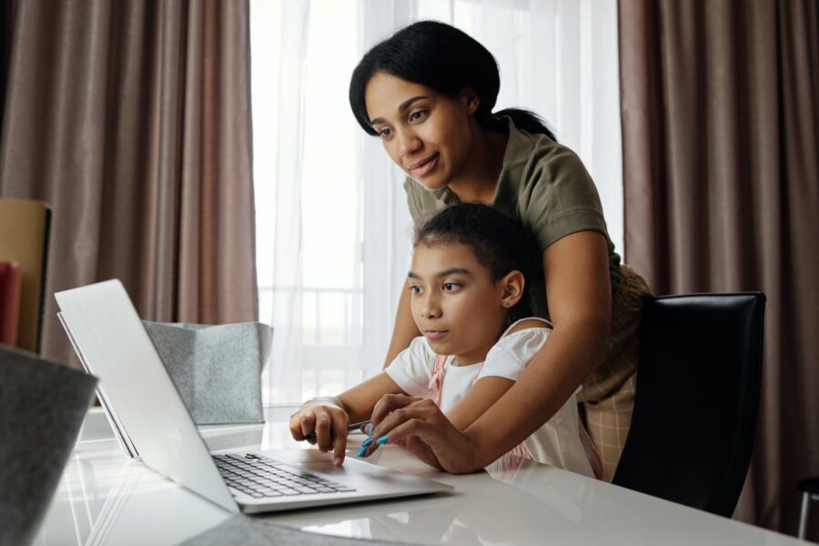 parent helping child learn virtually