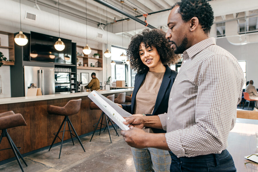 Two business professionals in a bright and airy workspace