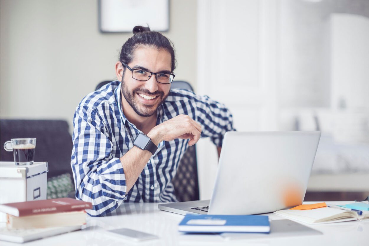 Casual male at desk with laptop