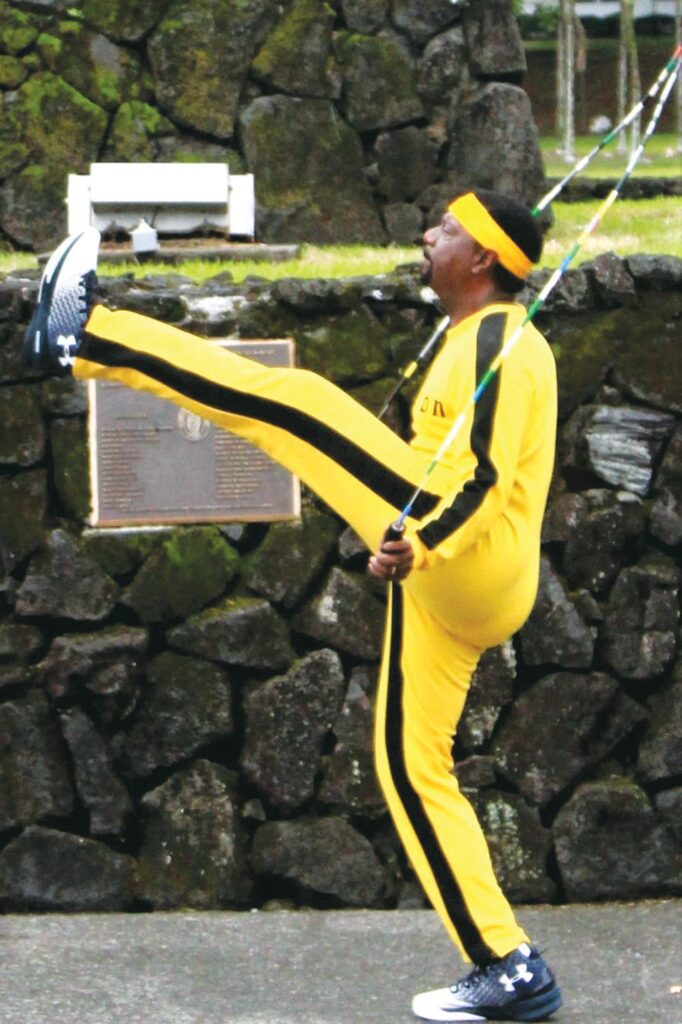 Donald Thomas jump roping in a yellow track suit.