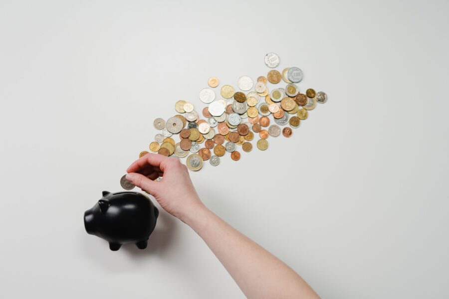 coins being put into a piggybank