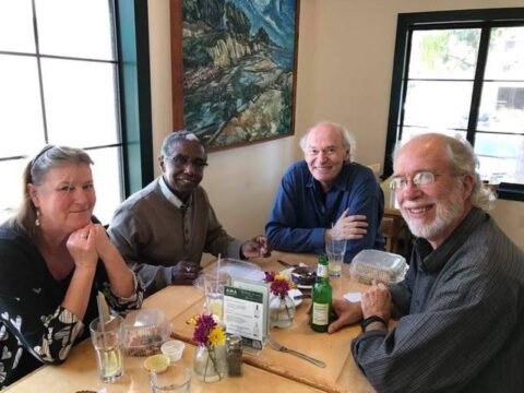 Richard Whitney at restaurant table with friends