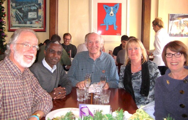 Richard Whitney at table with friends