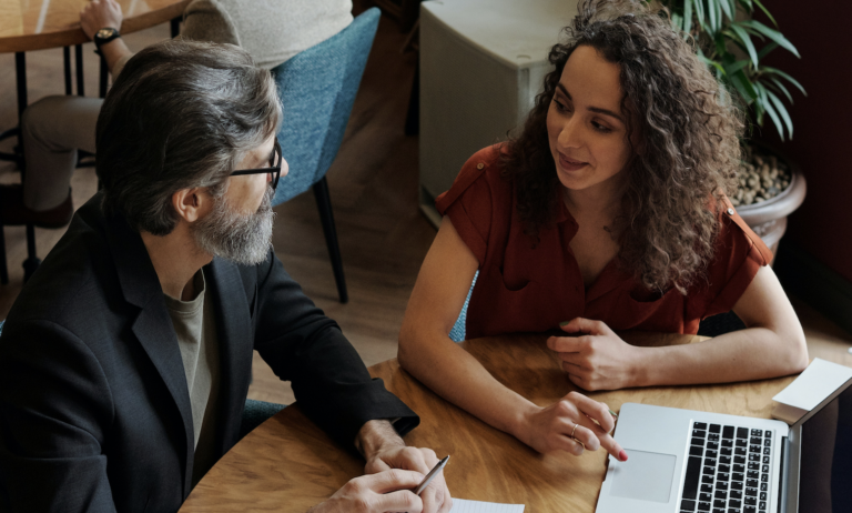 Professional people sitting at a table having a discussion.