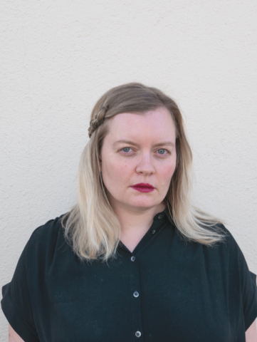 A younger woman with long blonde hair.