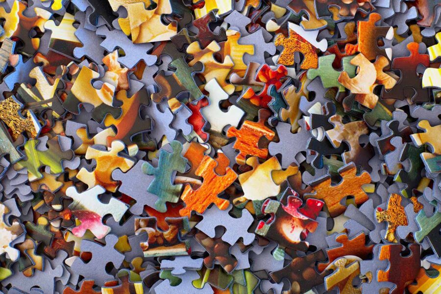 pile of puzzle pieces, of a variety of colors and shapes