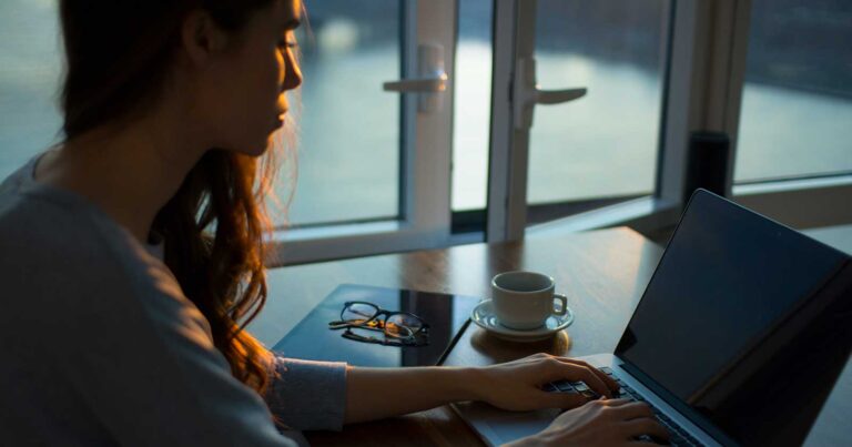 person sitting at a desk with a laptop