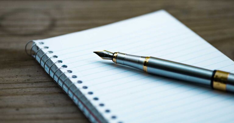 beautiful pen on empty notebook