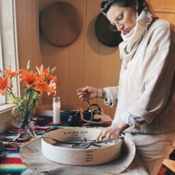 Woman in kitchen making botanicals