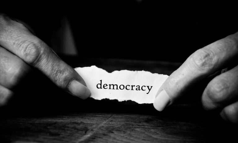 Word democracy held in hands