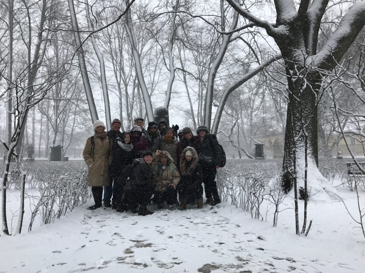 A photo showing about twelve people standing in the snow