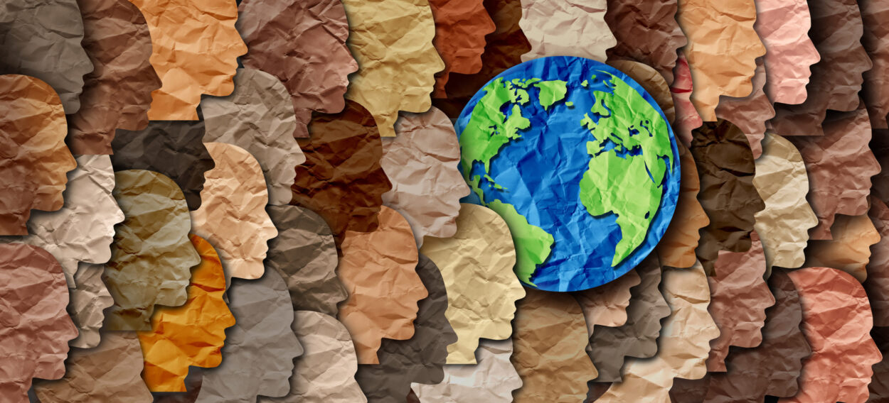 Paper planet earth surrounded by many diverse paper faces