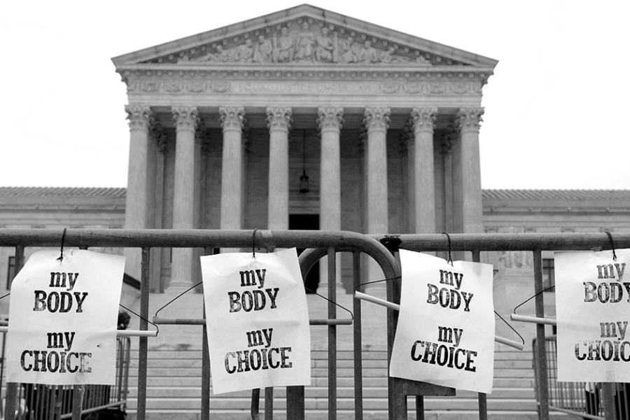 A photo of the Supreme Court of the United States building, behind a fence on which posters reading "My Body My Choice" have been attached.