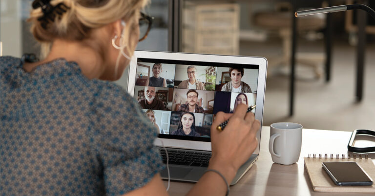 Anonymous woman faces a video conference with a pen in-hand