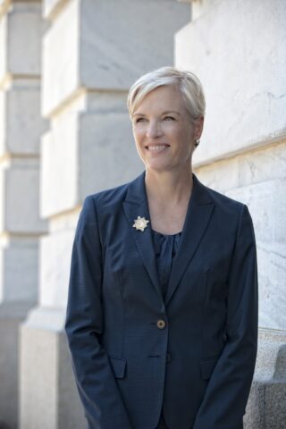 Cecile Richards standing in front of white wall