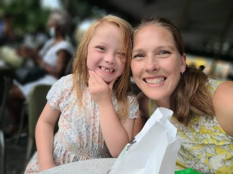 Subject smiles into camera with her young daughter, Kate