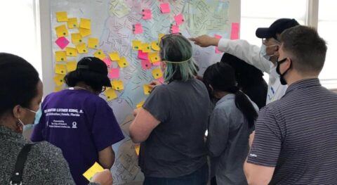 Multiple people working on a board