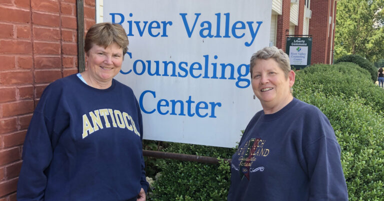 Antioch Alums in front of River Valley Counseling Center sign