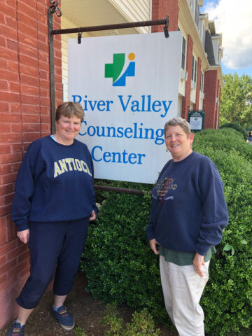 Susan M. Quigley, PsyD and Elaine F. Campbell, PsyD in front of River Valley Counseling Center Sign