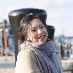 Huijun "Nikki" Li smiling wearing a scarf.