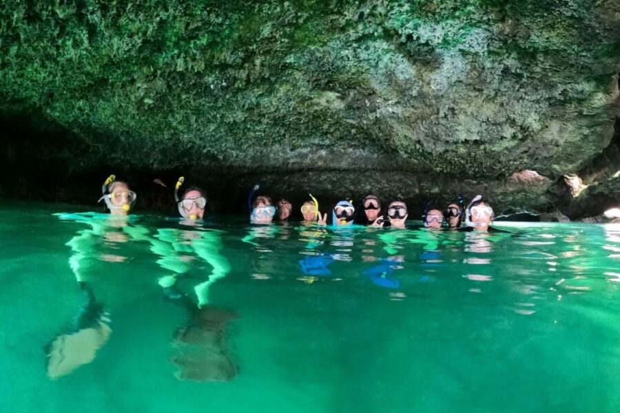 Alumni swim in beautiful green water
