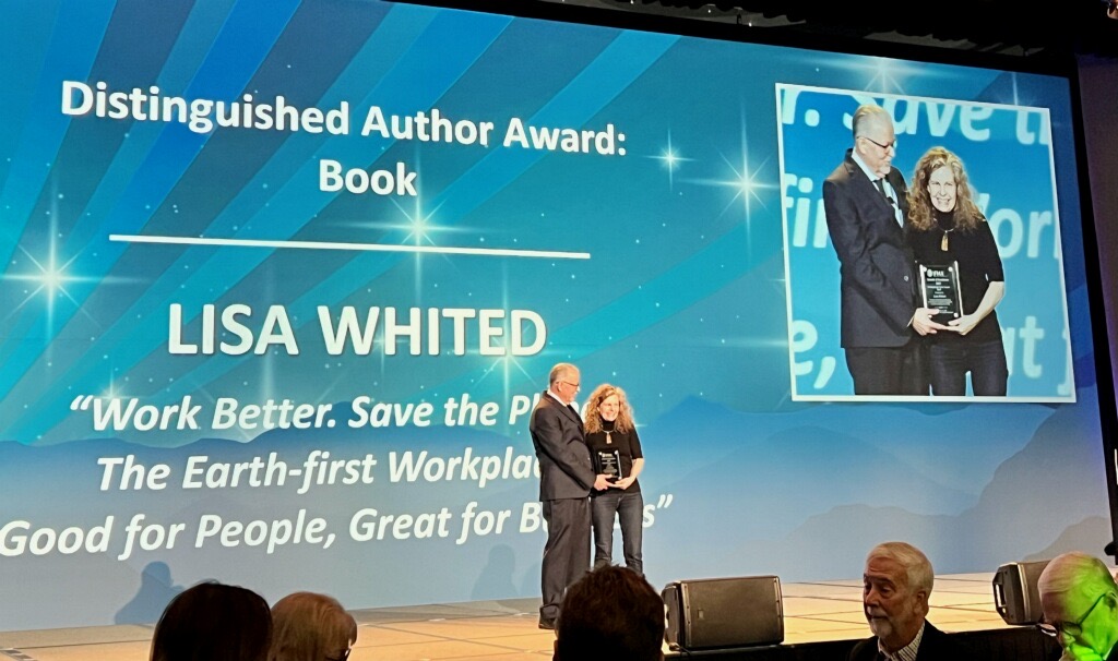 Lisa Whited receiving her Distinguished Author Award for her book on stage