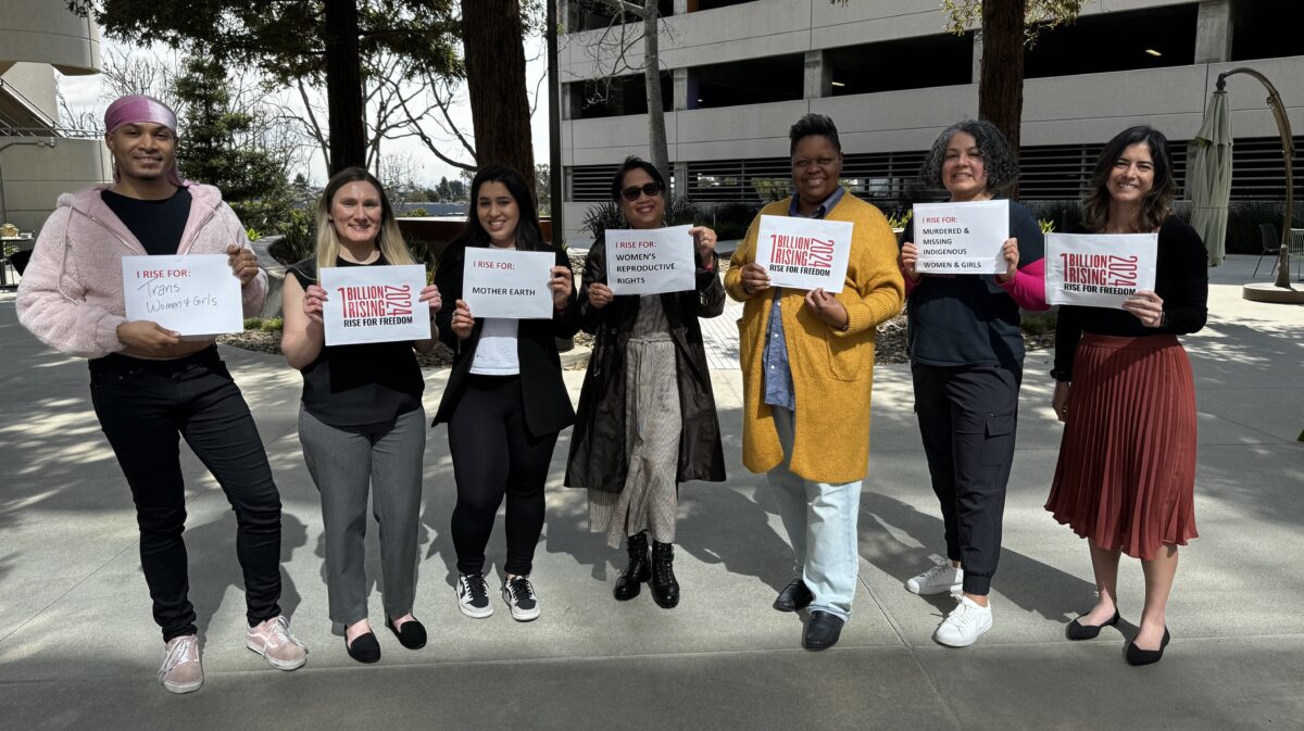 Photo from left to right: Healix Tolbert (MAP Student), Ellena Arellan (MAP Senior Academic Advisor), Ghazal Noor (Student Services), Emee Decanay (Executive Director Campus Enrollment Management and Student Services), Tenika Jackson (MAP Chair), Julie Rodriguez (MAP Program Coordinator), and Jenn Ellingwood (Director of Program Administration) standing outside holding signs for One Billion Rising.