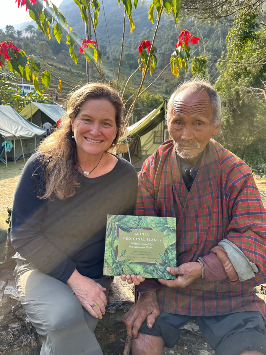 Murray and Ap Tawla in Monpaland in December 2023, holding the book they cocreated, both feeling proud of their documentation of Monpa plant wisdom. 
