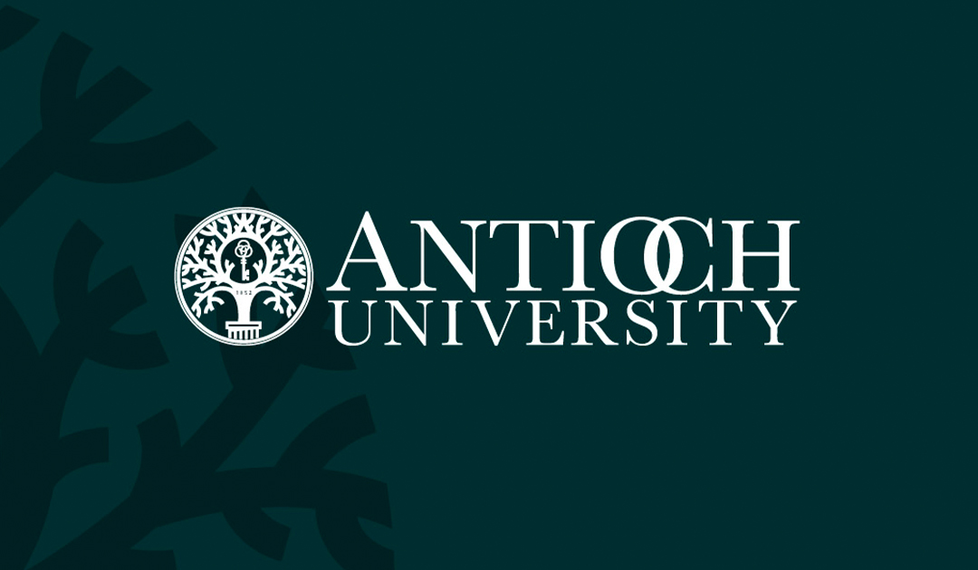 Antioch University logo with seal on green background over ghosted tree