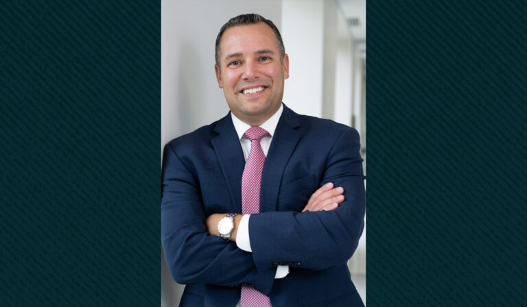 A portrait of Josh Jacobs in a suit