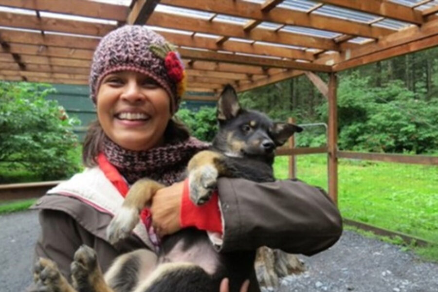 Priya Tallam, EdD, a 2025 graduate holding a lovely dog.