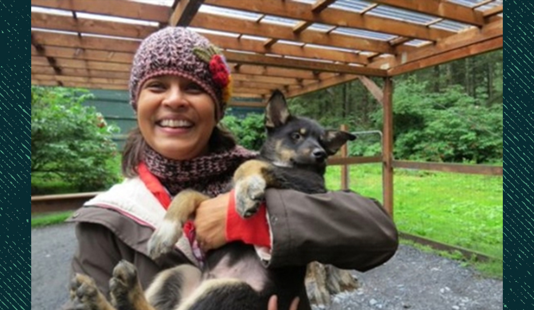 Priya Tallam, EdD, a 2025 graduate holding a lovely dog.