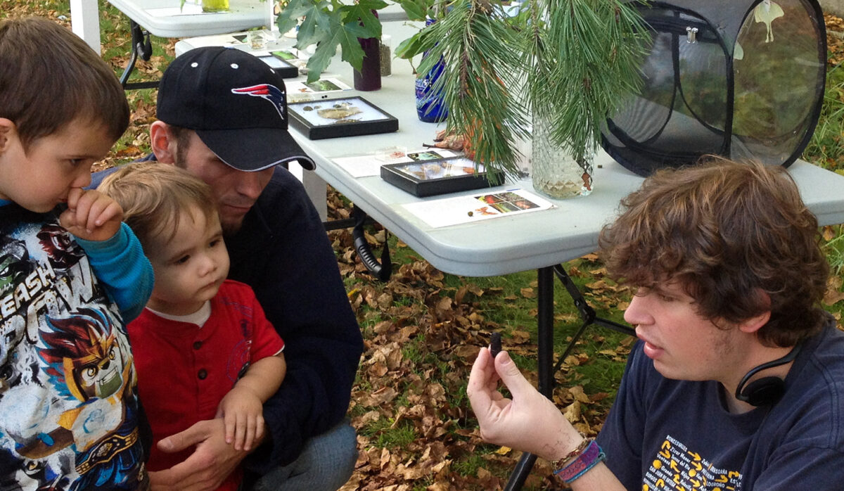 MS in Environmental Studies alumni Jesse Varga shares about the caterpillar life cycle while tabling for the Caterpillar Lab at a small event.
