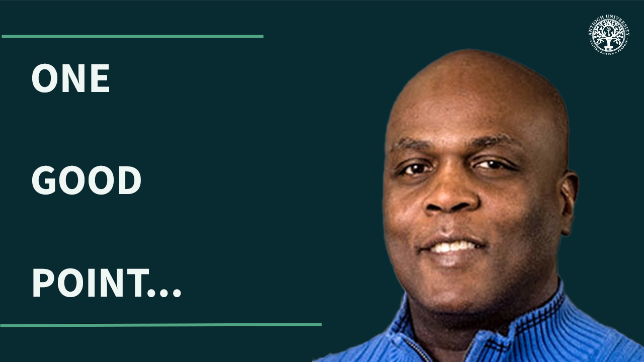 Graphic with dark green background featuring white text that reads ‘ONE GOOD POINT...’ on the left side. On the right is a headshot of Ken Williams wearing a blue sweater, smiling slightly. The Antioch University logo appears in the top right corner.