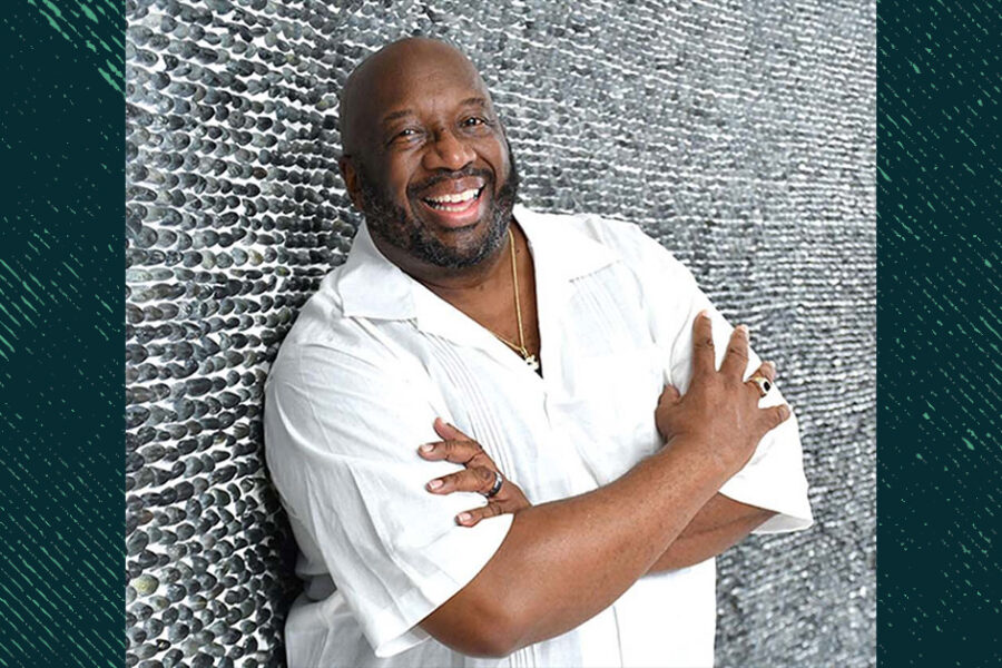 Russell-Thornhill, smiling and standing in front of a brick wall