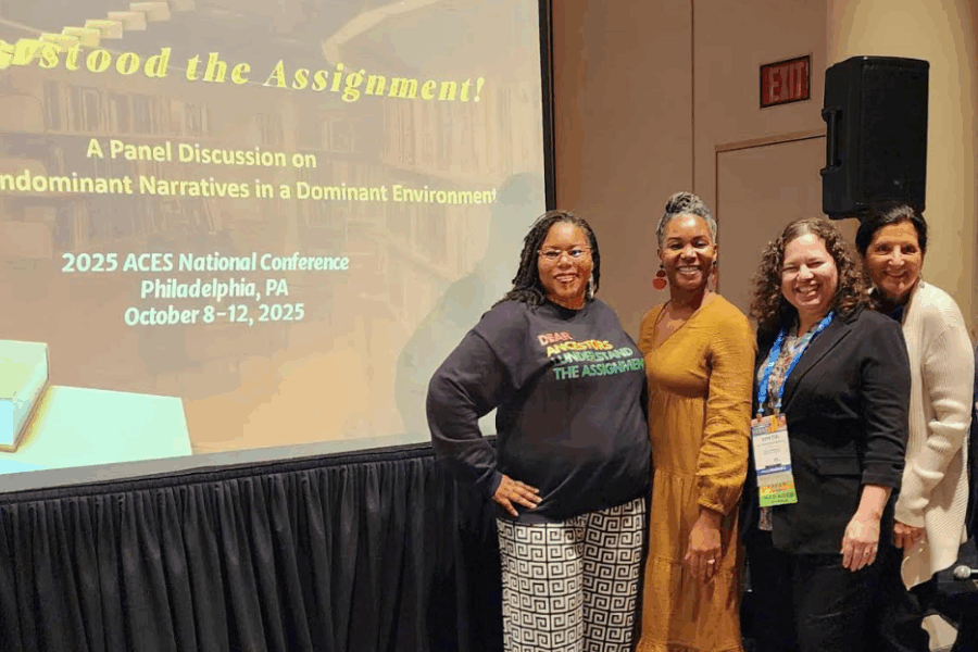 Group of panelists pose in front of a screen reading ‘We Understood the Assignment!—Publishing Nondominant Narratives in a Dominant Environment, 2025 ACES National Conference, Philadelphia, Oct 8–12, 2025.