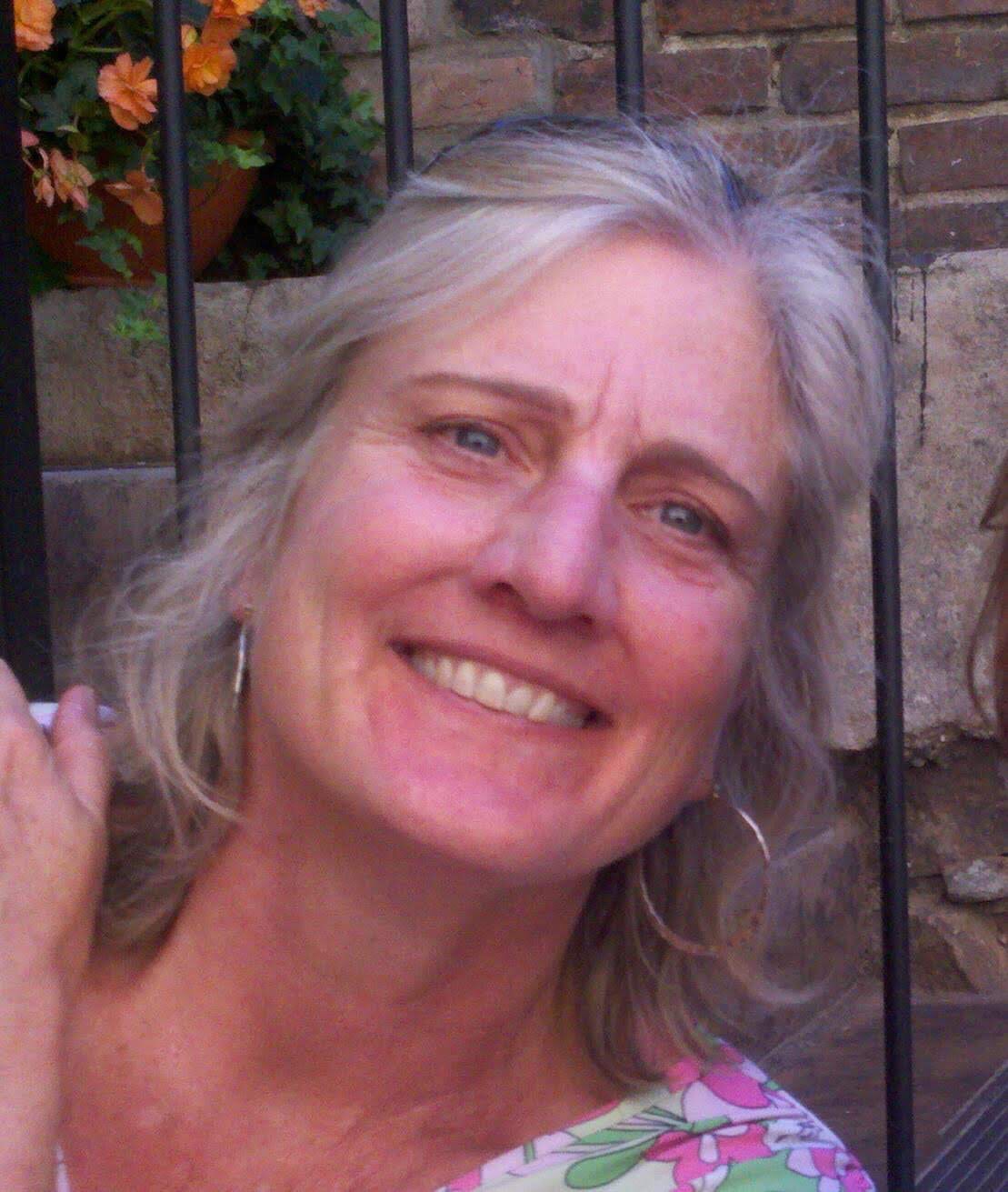 A portrait of Carla Beebe Comey smiling.