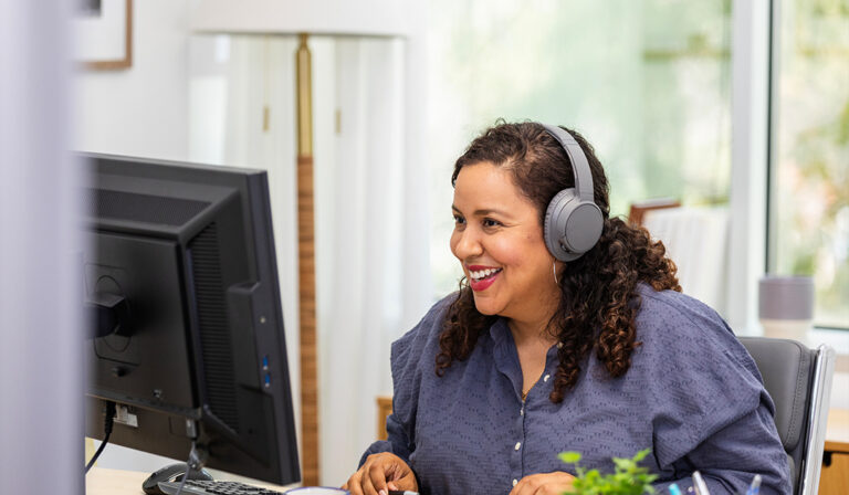 Using her desktop in her home office, the businesswoman is happy to meet with her client through a video call.