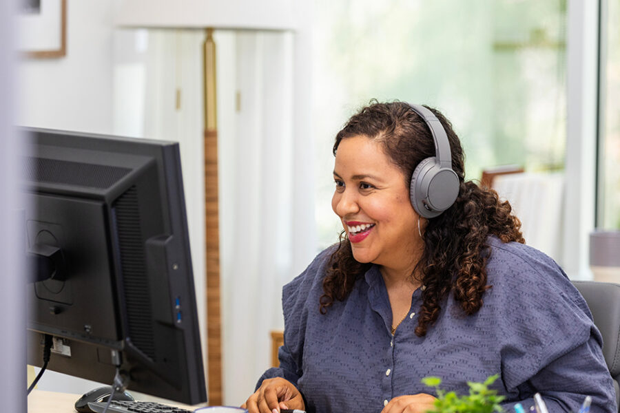Using her desktop in her home office, the businesswoman is happy to meet with her client through a video call.