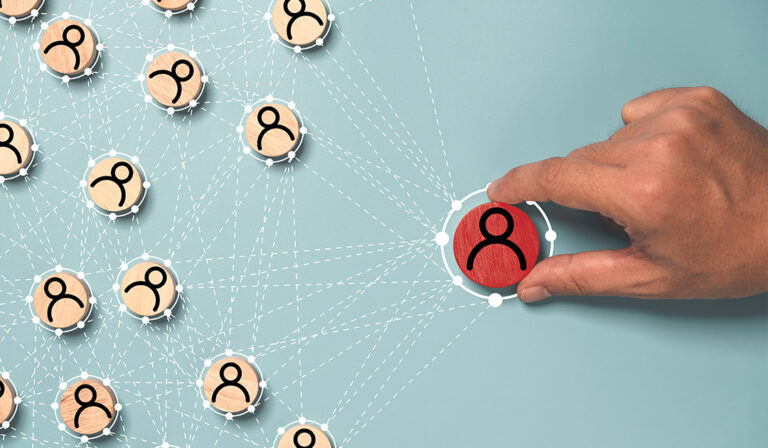 A hand selecting a highlighted red person icon within a connected network of smaller user icons, representing leadership or influence.