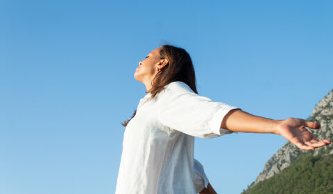 Somatic exercises, happy woman on the beach