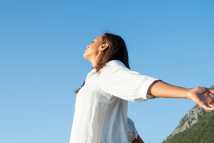 Somatic exercises, happy woman on the beach