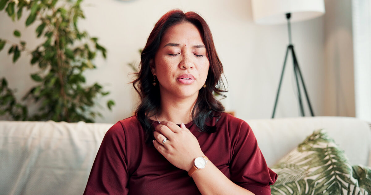 Breathe, somatic therapy and woman on sofa for healing, mindfulness and calm for holistic counseling. Psychology, therapist and person with breath work for awareness, emotion regulation or eft tapping