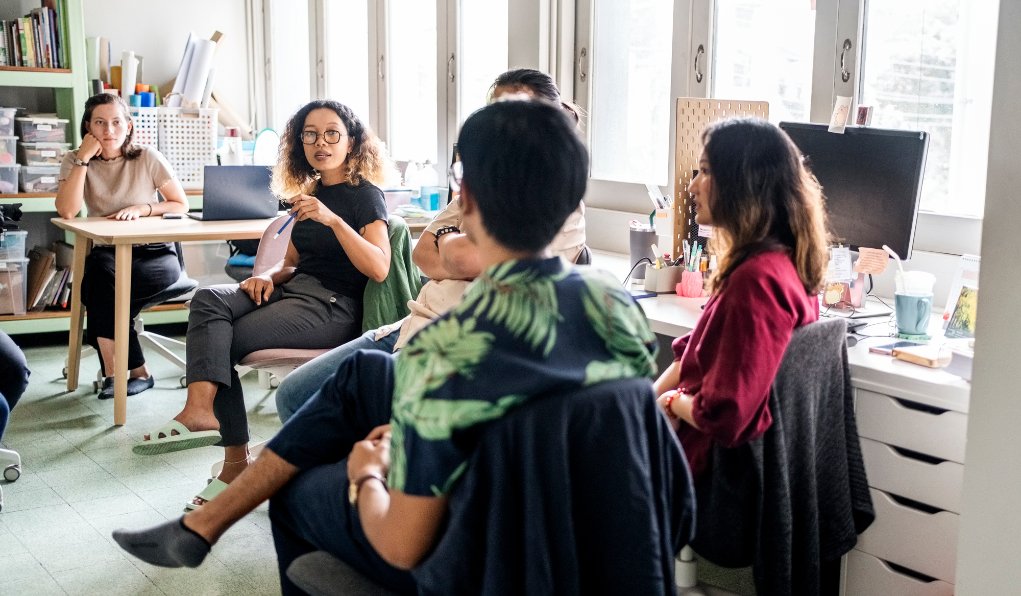 Team of businesspeople engaged in a discussion, working on a new project in non-profit organization office