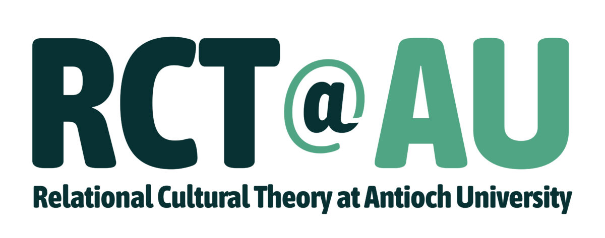 Logo for RCT@AU (Relational Cultural Theory at Antioch University). The design features the large text "RCT@AU," with "RCT" in dark teal, the "@" symbol outlined in light green with a dark teal center, and "AU" in light green. Beneath the acronym, the full name "Relational Cultural Theory at Antioch University" appears in dark teal. The logo is displayed on a white background.