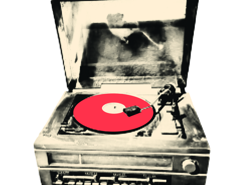A vintage turntable playing a red vinyl record with the needle on the groove.