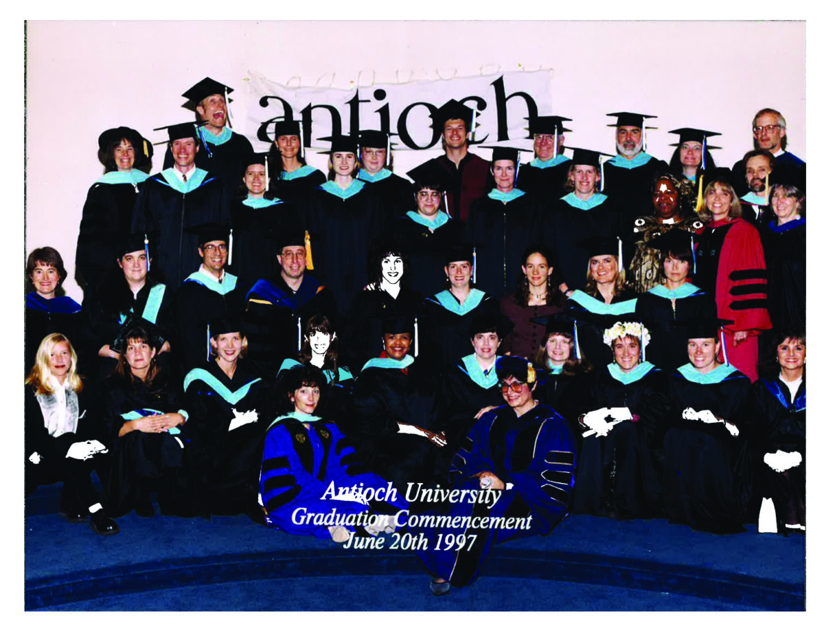 Group of graduates in caps and gowns posing for a class photo at Antioch University Graduation Commencement, June 20, 1997.